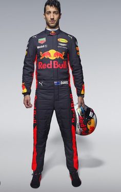 a man in a red bull racing suit holding a helmet