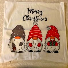 three snowmen with hats and scarfs are on a white pillow cover that says merry christmas