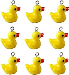 twelve yellow rubber ducks with red bows on them