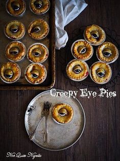 some pies are sitting on top of a pan and one has a fork in it