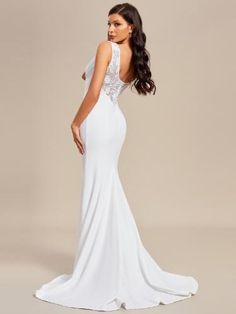 a woman in a white gown with an open back