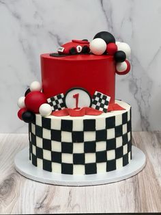 a red and black checkered cake with mickey mouse decorations