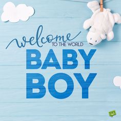 baby boy welcome sign with teddy bear hanging from clothesline on blue wood planks