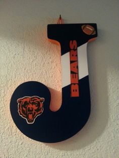 the chicago bears logo is mounted to the wall above the letter j on the wall