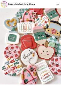 a pile of decorated cookies sitting on top of a white table next to each other