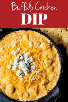 buffalo chicken dip in a cast iron skillet with cheese and crackers