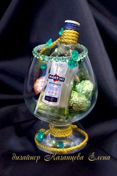 a glass vase filled with bottles and candy