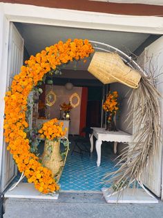 orange flowers are arranged on the outside of a house's front door to decorate it