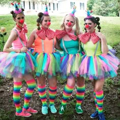 three girls dressed in clown costumes posing for the camera