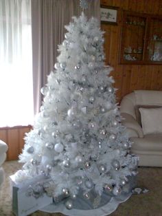 a white christmas tree in a living room