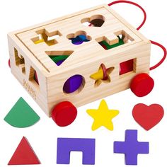 a wooden toy with different shapes and sizes on it's side, including an object that looks like a puzzle