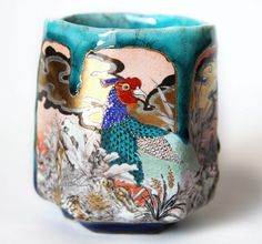 a cup with a bird painted on it