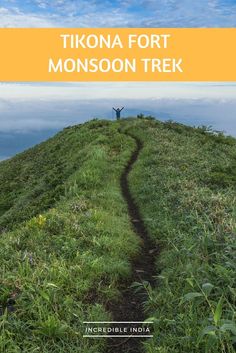 a person standing on top of a hill with the words tikona fort monsson trek