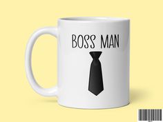 a white coffee mug with the words boss man on it and a black neck tie