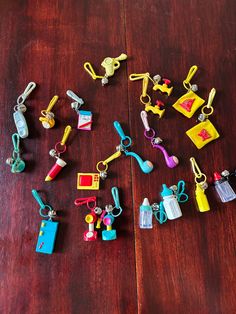 many small toy items are arranged on a wooden table with scissors and toothbrushes