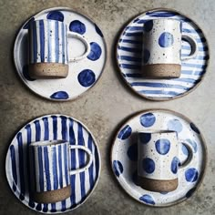 four blue and white plates with coffee cups on them