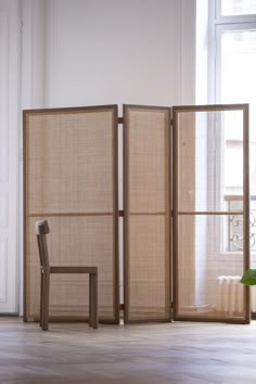 an open room divider with a chair next to it