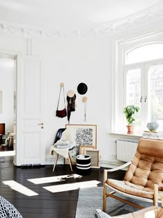 a living room filled with furniture and lots of windows