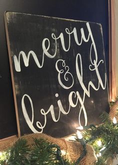 a merry and bright sign hanging from the side of a christmas tree