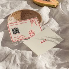 a piece of paper sitting on top of a table next to a bowl filled with fruit