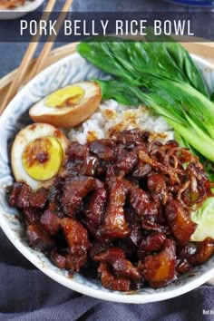 pork belly rice bowl with chopsticks and green onions on the side in a white bowl