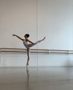 a ballerina standing in the middle of an empty room