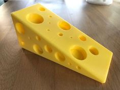 a piece of cheese sitting on top of a wooden table