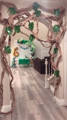 a living room decorated for st patrick's day with paper garlands and balloons