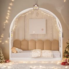 a room decorated for christmas with lights on the ceiling and white furniture in front of it