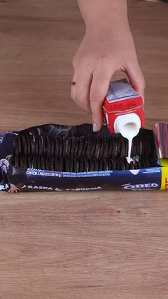 a person is using a brush to clean an oreo cookie