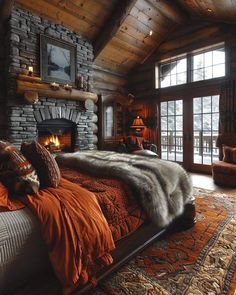 a bedroom with a stone fireplace and large bed in the center, surrounded by orange pillows