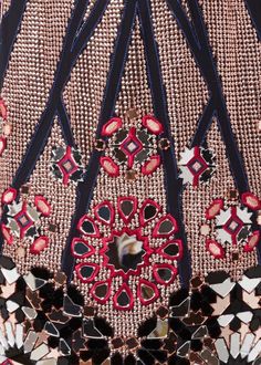 the back of a dress with red and black beads on it