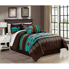 a bed with brown and blue comforters in a room