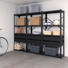 a bike is parked next to a shelf with boxes and other items