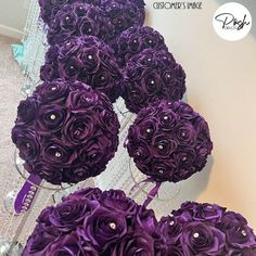 purple flowers are arranged in a row on the floor