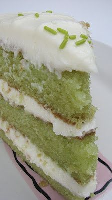 a piece of green cake with white frosting