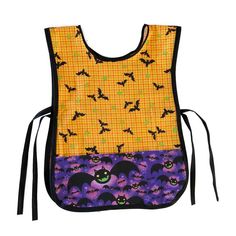 a bib with bats and pumpkins on it, one is yellow and the other is purple