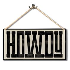 a black and white sign with the word hollywood hanging from a rope