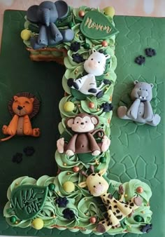 a green cake with animals on it