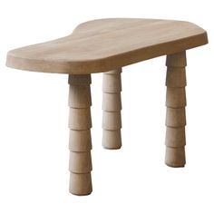 a small wooden table with four legs on the top and one leg raised up to the side