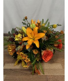 a vase filled with orange and yellow flowers