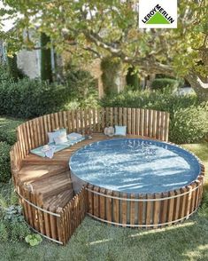 a hot tub sitting on top of a lush green field