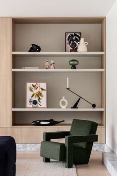 a living room filled with furniture and bookshelves next to a wall mounted shelf