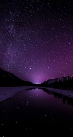 the night sky is filled with stars and purple hues as it reflects in water