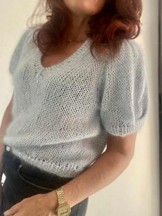 a woman with red hair is posing for the camera