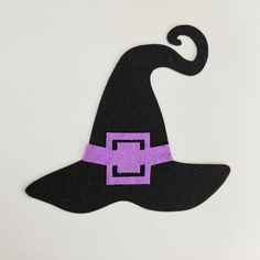 a felt witch's hat with a purple square on it and black brim