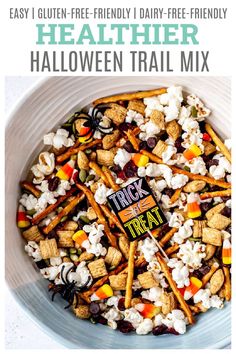 a white bowl filled with halloween trail mix