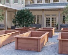 a group of wooden planters sitting in front of a building