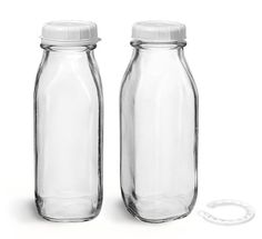 two empty glass jars sitting next to each other