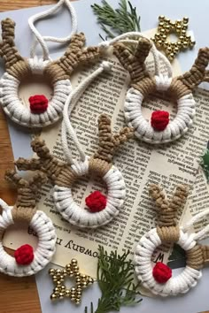 christmas ornaments made out of yarn and twine on top of an old book page